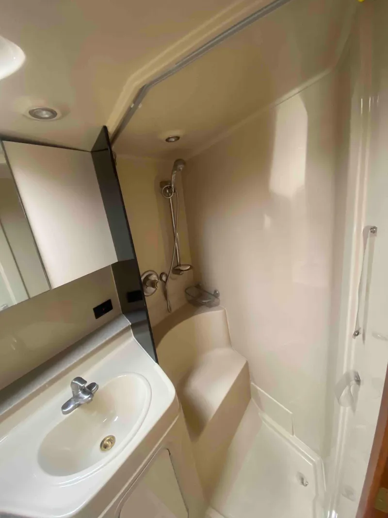 Slide: The Image of 2004 Cruisers Yachts 340 Express bathroom with sink, toilet, and shower. - 38