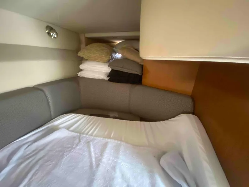 Slide: The Image of Interior cabin of 2004 Cruisers Yachts 340 Express with bed and folded chair. - 40