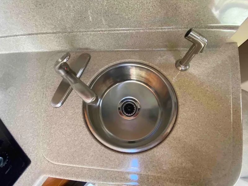 Slide: The Image of Stovetop on 2004 Cruisers Yachts 340 Express, featuring dual burners and control knobs. - 45