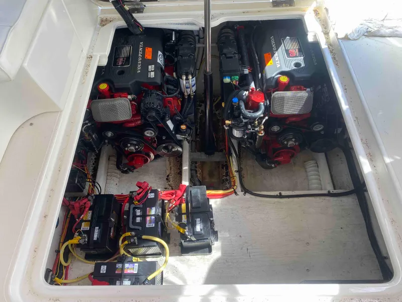 Slide: The Image of 2004 Cruisers Yachts 340 Express cabin interior with porthole and cushions. - 48