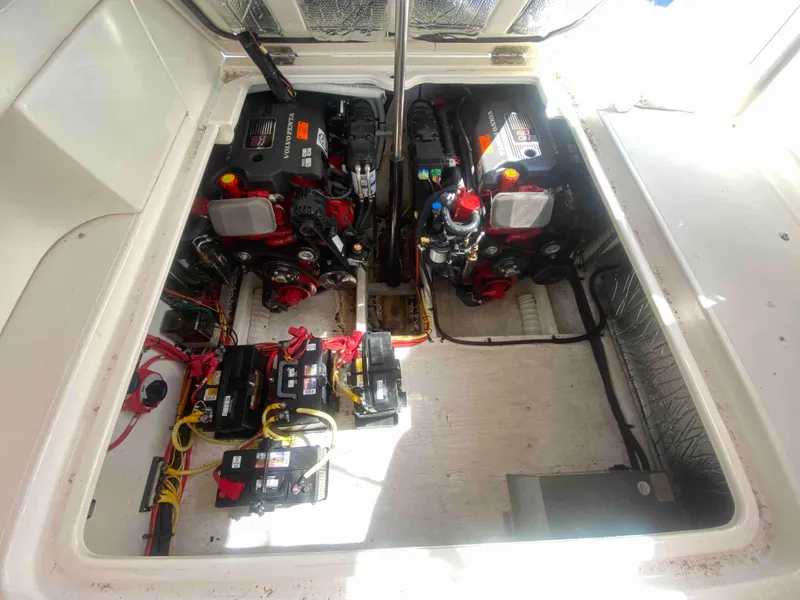 Slide: The Image of Engine compartment of 2004 Cruisers Yachts 340 Express, featuring dual engines and battery setup. - 49