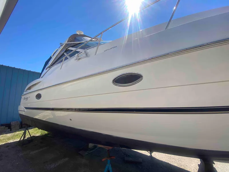 Slide: The Image of 2004 Cruisers Yachts 340 Express on dry dock, hull view. - 5