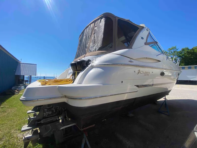 Slide: The Image of 2004 Cruisers Yachts 340 Express boat under bright sunlight, side view. - 6