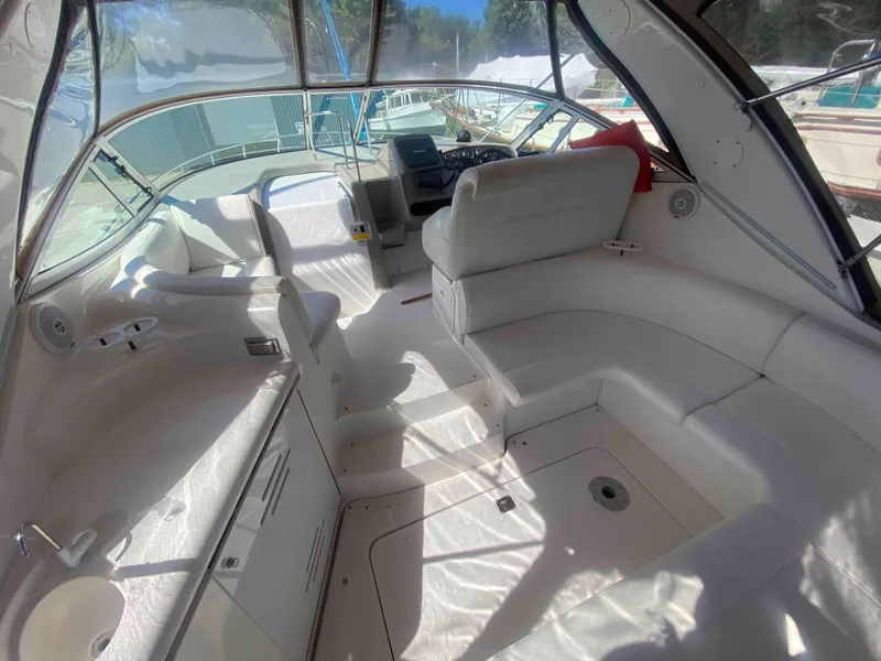 Slide: The Image of 2004 Cruisers Yachts 340 Express on land, rear view with "Symon Says" text. - 8