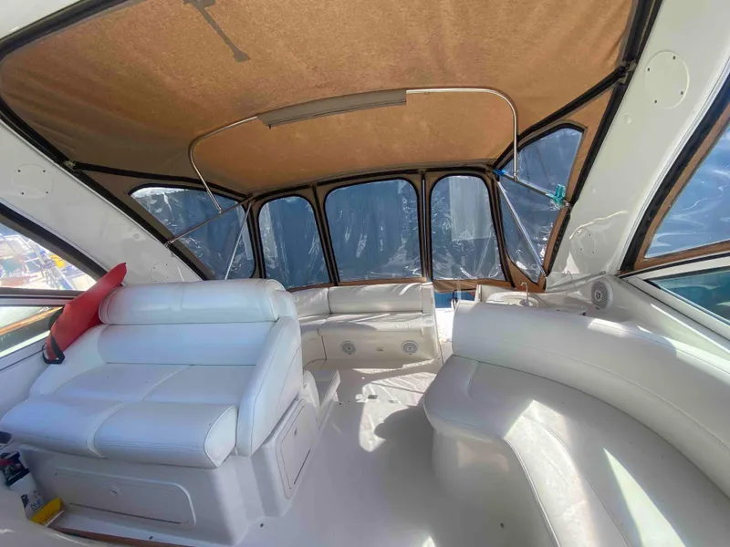 Slide: The Image of 2004 Cruisers Yachts 340 Express interior with white seating and helm. - 9