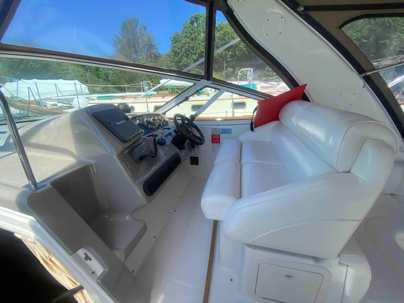 Slide: The Image of 2004 Cruisers Yachts 340 Express interior with white seating and large windows. - 11