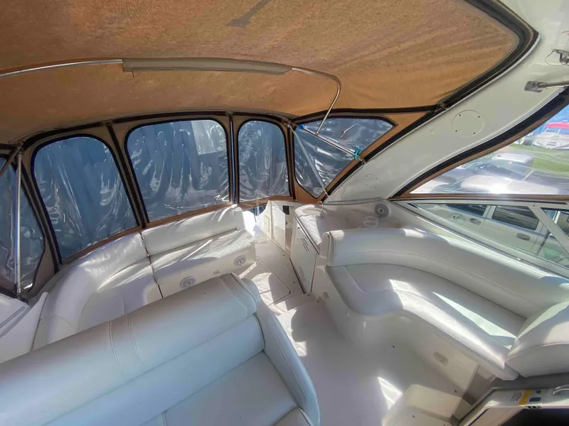 Slide: The Image of 2004 Cruisers Yachts 340 Express interior with white seating and panoramic windows. - 14