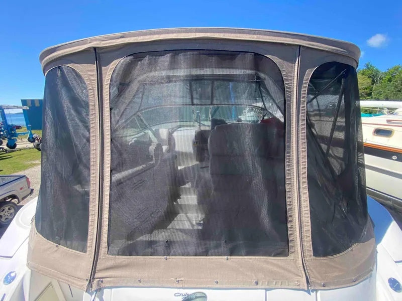 Slide: The Image of 2004 Cruisers Yachts 340 Express cockpit with steering wheel and seating area. - 23