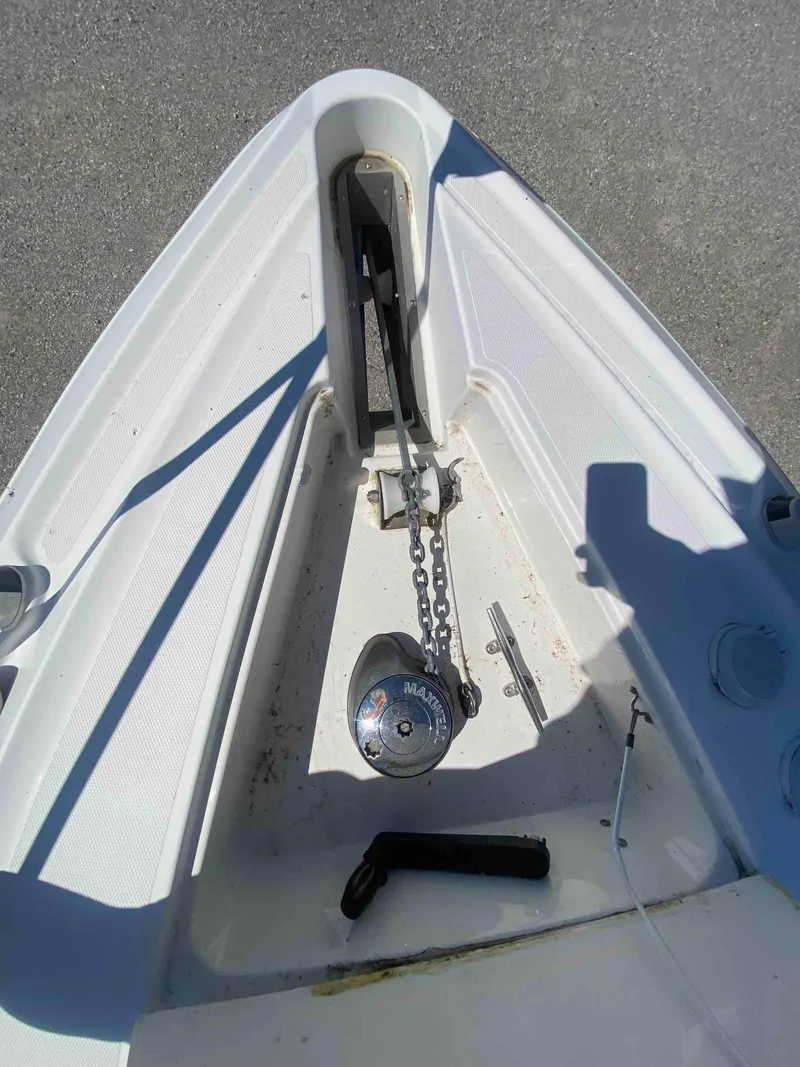 Slide: The Image of 2004 Cruisers Yachts 340 Express with mesh canopy, docked under clear blue sky. - 24