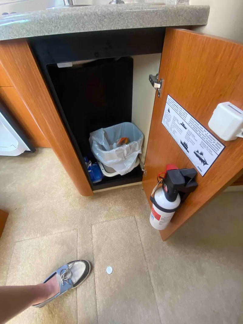 Slide: The Image of 2004 Cruisers Yachts 340 Express closet with hangers and folded clothes. - 42