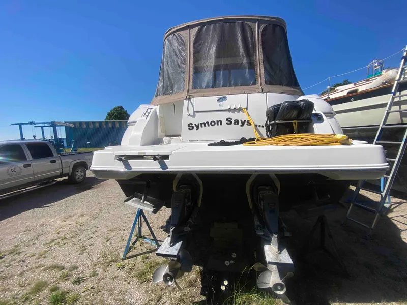 Slide: The Image of 2004 Cruisers Yachts 340 Express on land, side view, under clear blue sky. - 7