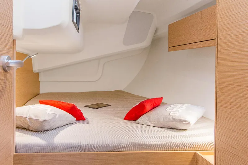 Slide: The Image of Cozy cabin interior of 2025 Hanse 418 yacht with modern design and colorful pillows. - 14