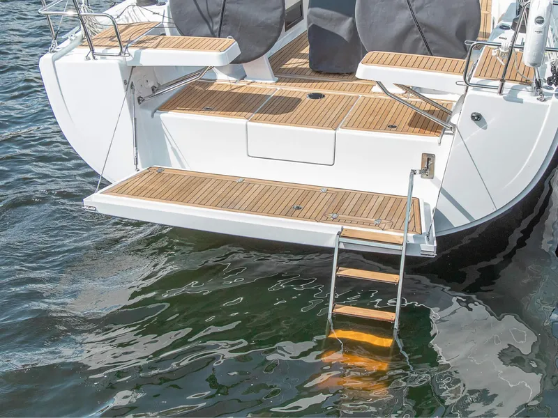 Slide: The Image of 2025 Hanse 418 yacht stern with teak deck and swim ladder. - 2