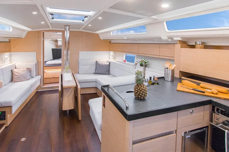 Slide: The Image of Luxurious interior of 2025 Hanse 418 yacht with modern kitchen and seating area. - 4