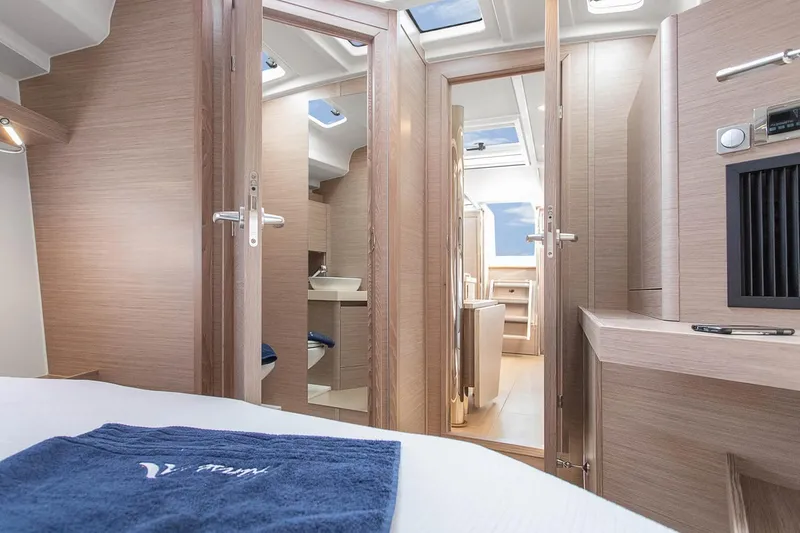 Slide: The Image of Interior of 2025 Hanse 418 yacht, featuring modern wood finish and natural lighting. - 13