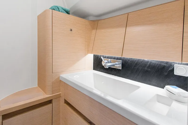 Slide: The Image of Modern bathroom interior in 2025 Hanse 418 yacht, featuring sleek wood cabinetry and a stylish sink. - 16