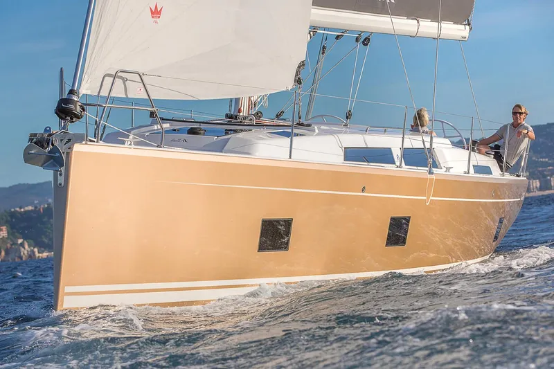 Slide: The Image of 2025 Hanse 418 sailboat navigating ocean waves under clear skies. - 20