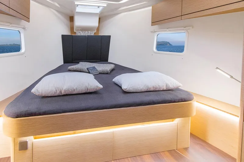 Slide: The Image of Luxurious cabin interior of 2025 Hanse 418 yacht with modern bedding and ambient lighting. - 9
