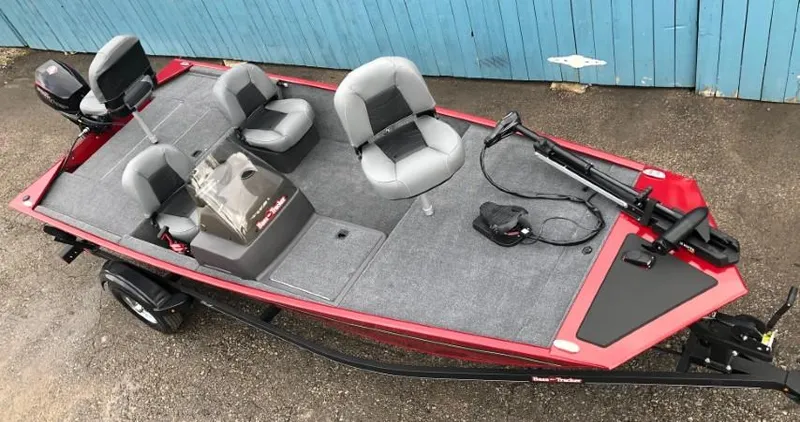 Slide: The Image of 2024 Tracker Bass Tracker Classic XL fishing boat with red exterior and gray seating. - 2