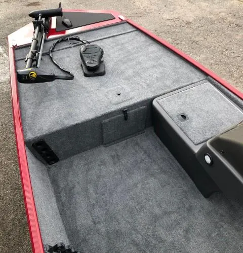 Slide: The Image of 2024 Tracker Bass Tracker Classic XL boat interior with gray carpet and trolling motor. - 4
