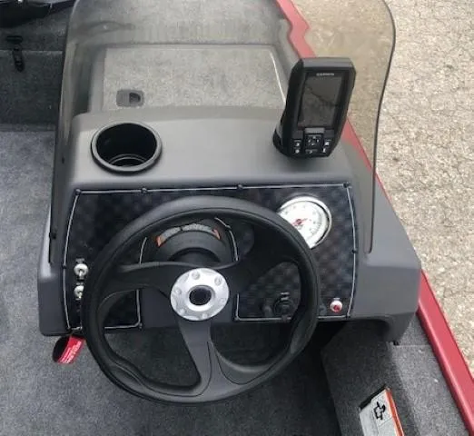 Slide: The Image of 2024 Tracker Bass Tracker Classic XL dashboard with steering wheel and fish finder. - 8