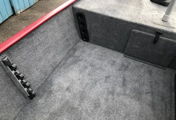 Slide: The Image of 2024 Tracker Bass Tracker Classic XL interior with gray carpet and red trim. - 9