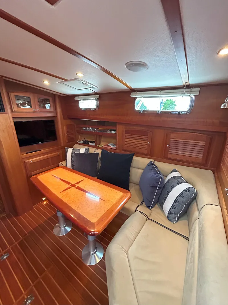 Slide: The Image of 2006 Sabre 38 Express HDTP MY interior with plush seating and scenic marina view. - 11