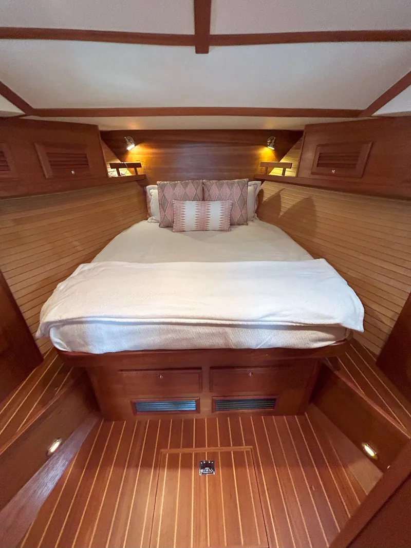 Slide: The Image of 2006 Sabre 38 Express HDTP MY yacht with striped seating and wooden table on deck. - 17