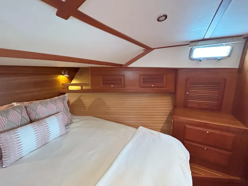 Slide: The Image of Interior of 2006 Sabre 38 Express HDTP MY yacht with wood paneling and cozy seating area. - 19