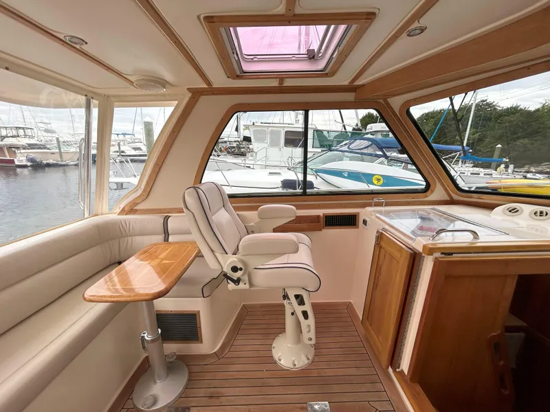 Slide: The Image of 2006 Sabre 38 Express HDTP MY yacht kitchen with stove, sink, and wooden cabinetry. - 24