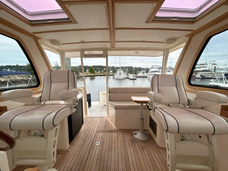 Slide: The Image of Interior of 2006 Sabre 38 Express HDTP MY yacht with wooden finishes and seating area. - 25