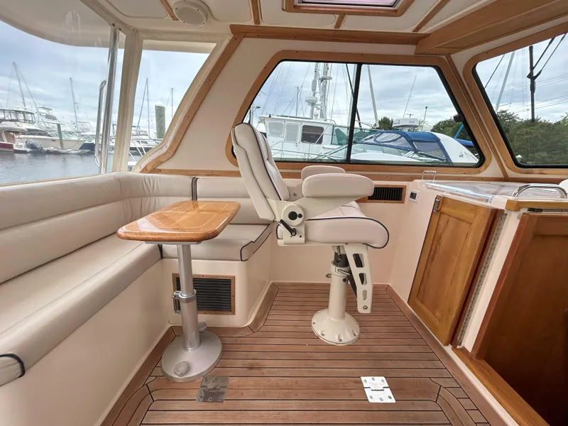 Slide: The Image of 2006 Sabre 38 Express HDTP MY cabin with cozy bed and wooden interior. - 26