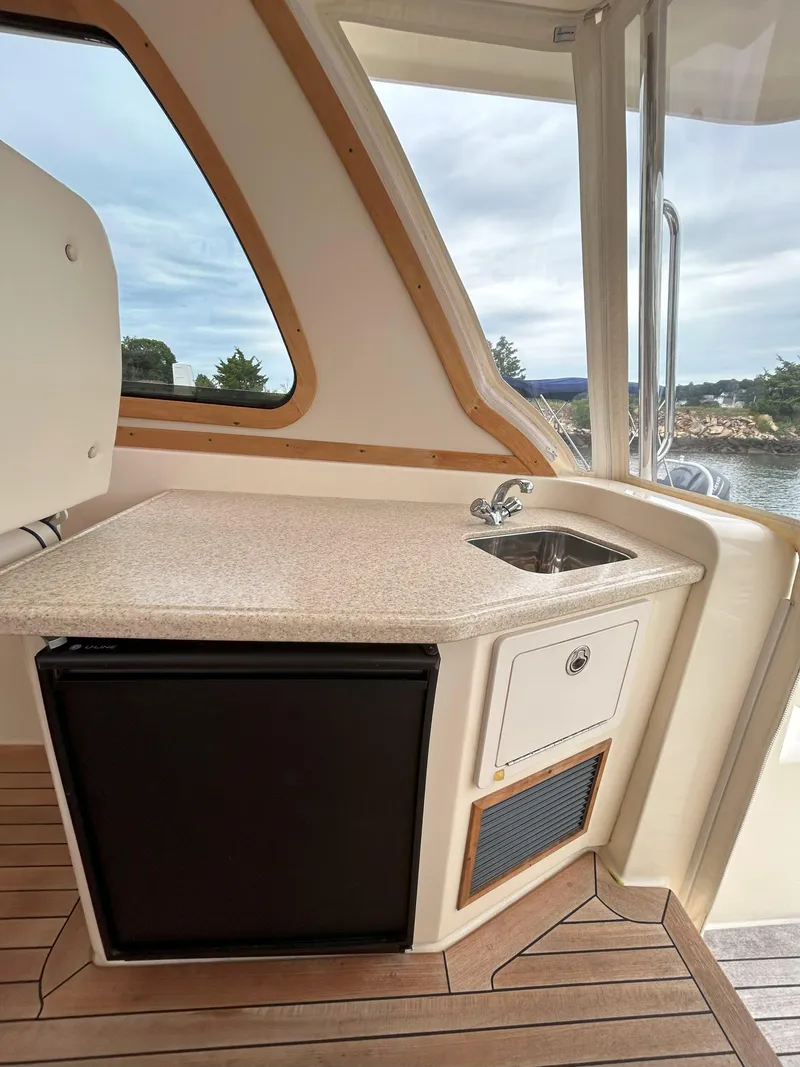 Slide: The Image of Cozy cabin interior of 2006 Sabre 38 Express HDTP MY with wood finish and bedding. - 28