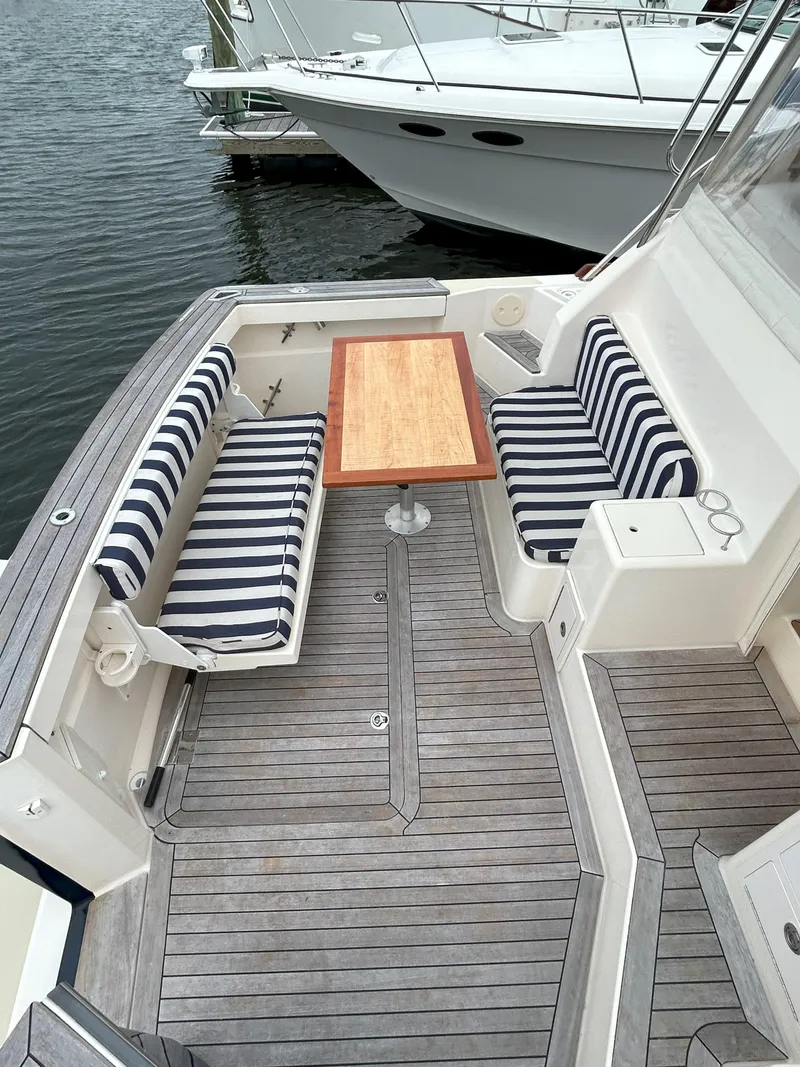 Slide: The Image of 2006 Sabre 38 Express HDTP MY yacht docked in a marina, under a cloudy sky. - 6