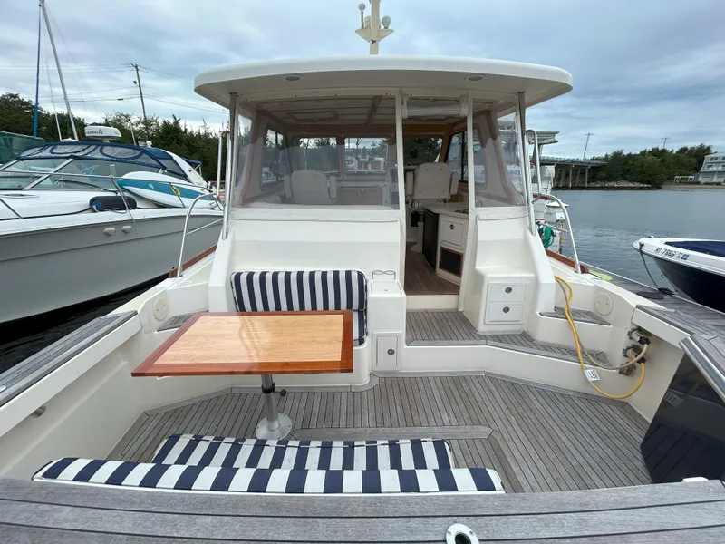 Slide: The Image of 2006 Sabre 38 Express HDTP MY docked at marina with swim platform. - 8