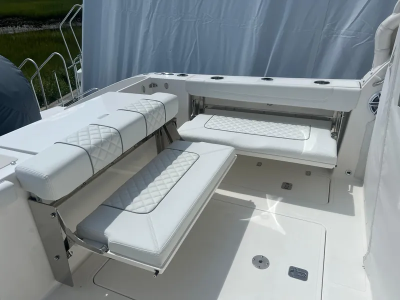 Slide: The Image of 2024 Pursuit DC 306 Dual Console boat with white cushioned seating and sleek design. - 11