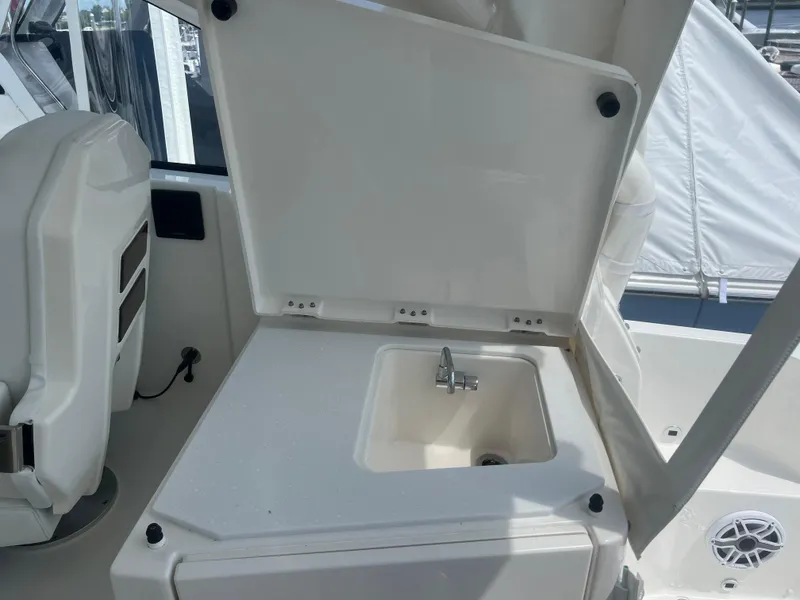 Slide: The Image of 2024 Pursuit DC 306 Dual Console boat with open sink compartment. - 14