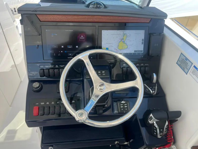 Slide: The Image of 2024 Pursuit DC 306 Dual Console helm with navigation screens and controls. - 22