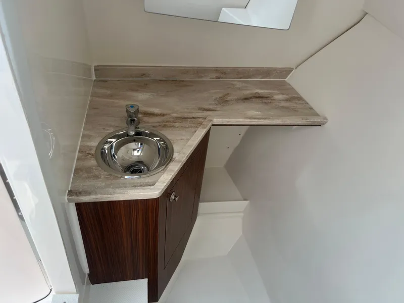 Slide: The Image of 2024 Pursuit DC 306 Dual Console boat interior with sink and countertop. - 26