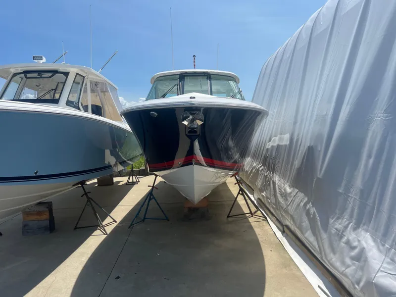 Slide: The Image of 2024 Pursuit DC 306 Dual Console boat on display between two covers. - 3