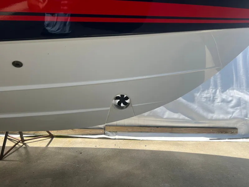 Slide: The Image of 2024 Pursuit DC 306 Dual Console boat hull with a visible thruster. - 6