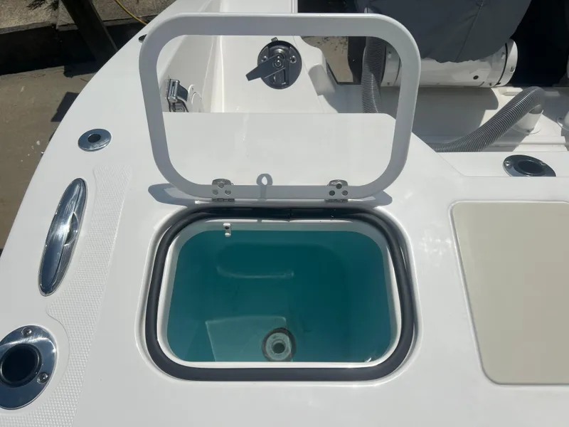 Slide: The Image of 2024 Pursuit DC 306 Dual Console boat with open livewell compartment. - 9