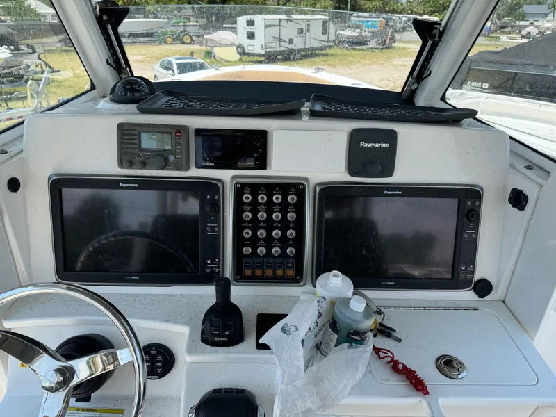Slide: The Image of 2013 Everglades 355 Tournament boat dashboard with navigation equipment and controls. - 13