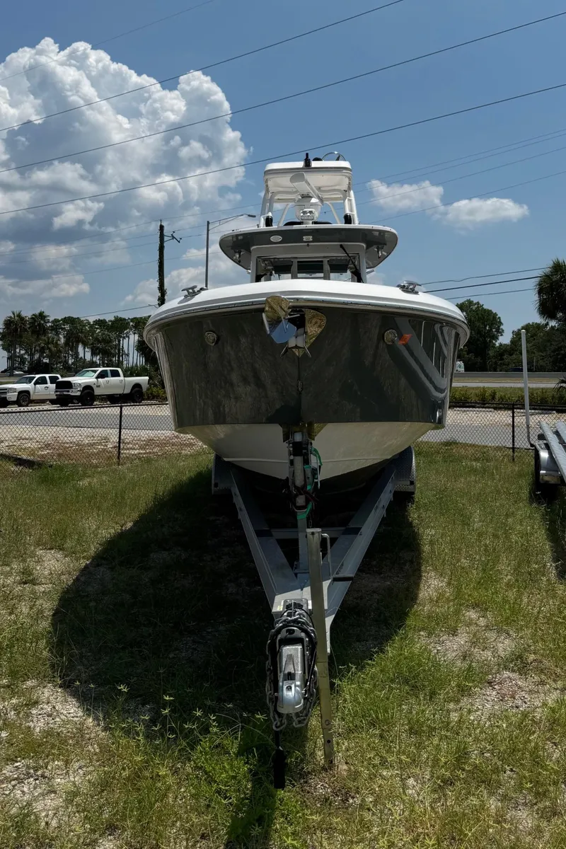 Slide: The Image of 2013 Everglades 355 Tournament boat on trailer, parked outdoors under a partly cloudy sky. - 3