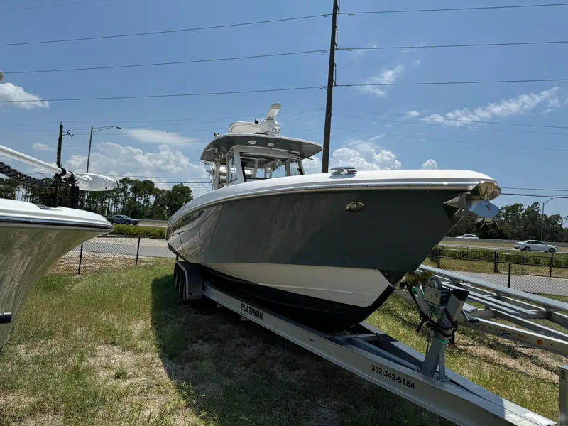 Slide: The Image of 2013 Everglades 355 Tournament boat on trailer, parked outdoors under clear sky. - 4