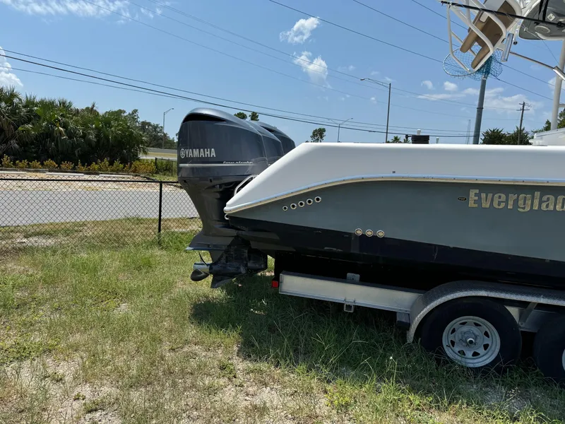 Slide: The Image of 2013 Everglades 355 Tournament boat with Yamaha engine on trailer, parked on grass. - 7
