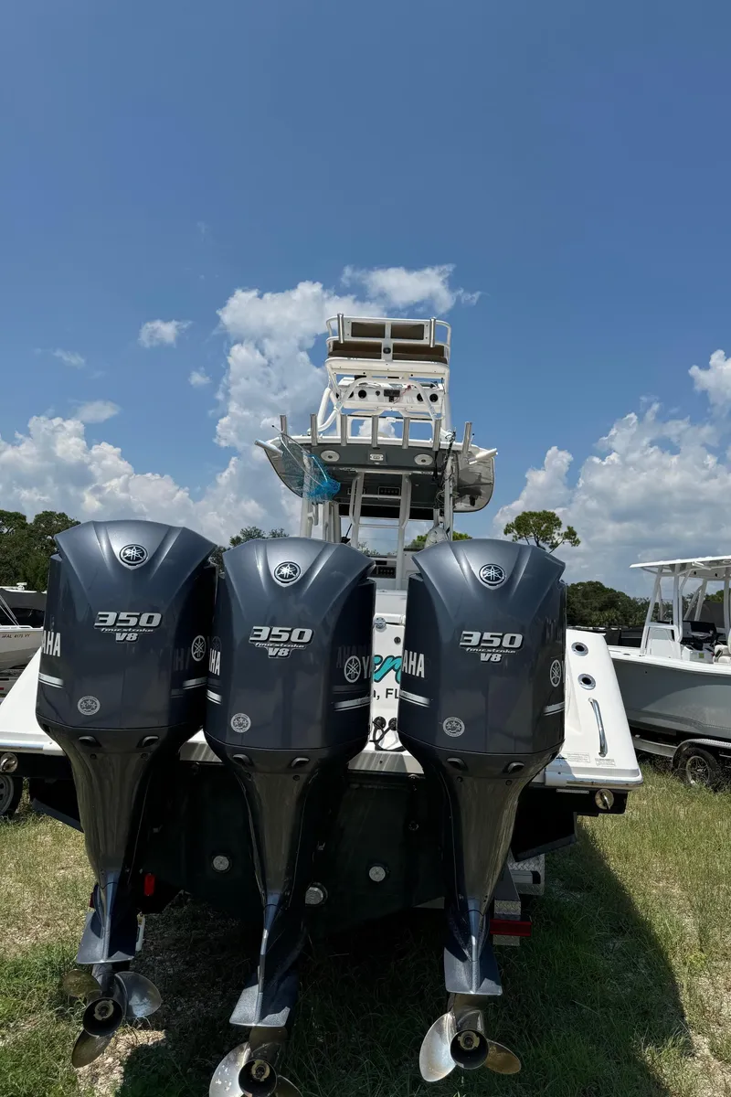Slide: The Image of 2013 Everglades 355 Tournament boat with triple Yamaha 350 engines, parked outdoors. - 8