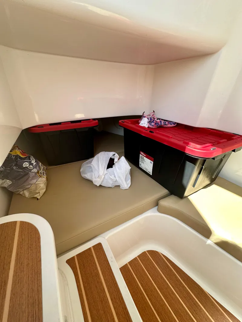 Slide: The Image of Interior of 2019 Edgewater 280CC boat with storage bins and wooden flooring. - 11