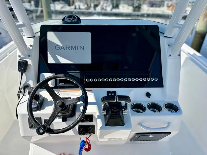 Slide: The Image of Edgewater 280CC 2019 boat dashboard with Garmin navigation system and steering wheel. - 12