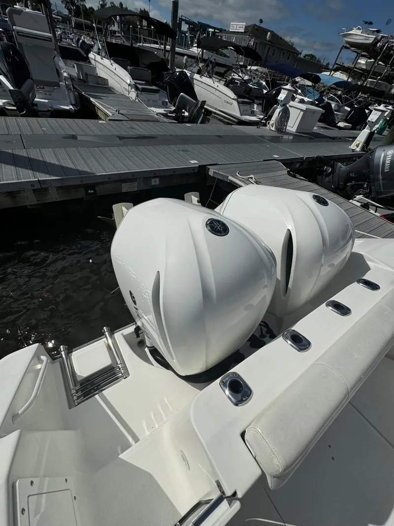 Slide: The Image of 2019 Edgewater 280CC boat with dual engines docked at marina. - 22